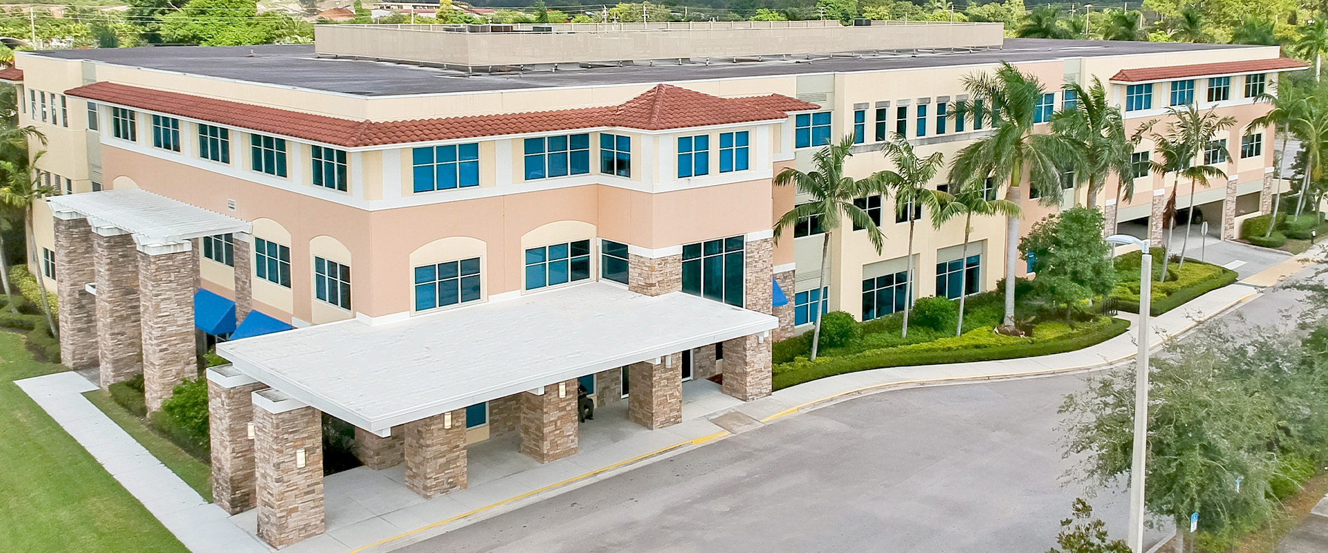 Healthcare facility exterior featuring modern architecture, landscaped surroundings, and a welcoming entrance, representing Leighton McGinn's commitment to innovative healthcare construction in Florida.