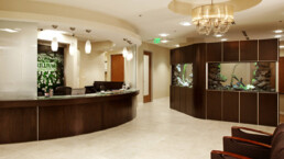 A lobby with reception desk and aquarium in it.