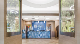A lobby with a blue and white tile wall.